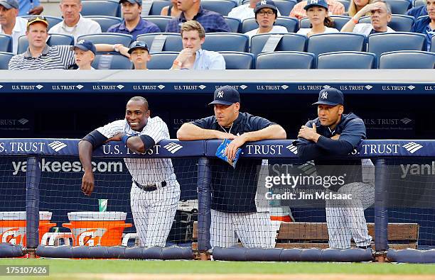 Alfonso Soriano, Kevin Youkilis and Derek Jeter of the New York Yankees look on in the first inning against the Tampa Bay Rays at Yankee Stadium on...