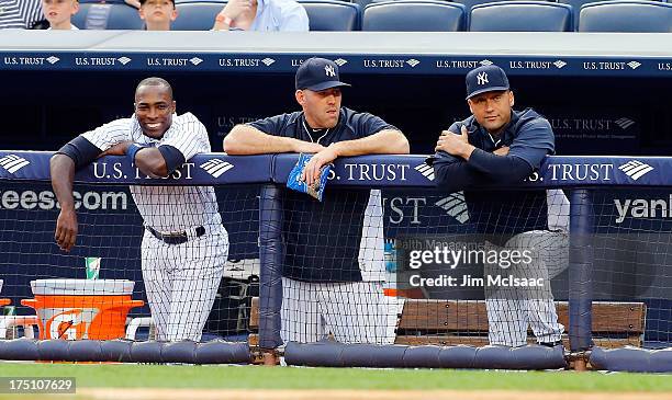 Alfonso Soriano, Kevin Youkilis and Derek Jeter of the New York Yankees look on in the first inning against the Tampa Bay Rays at Yankee Stadium on...