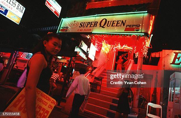 Touts try to draw customers into a club in the infamous Patpong road red light district in central Bangkok. Visits to the red light district which is...