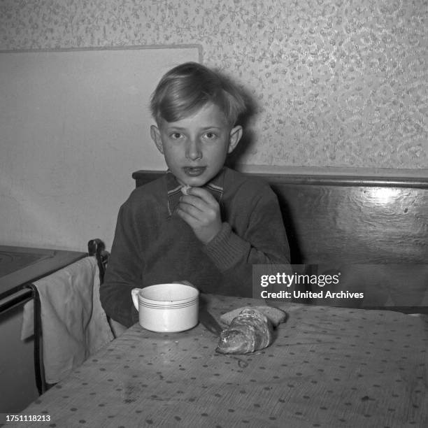 Boy having breakfast, Germany 1950s.