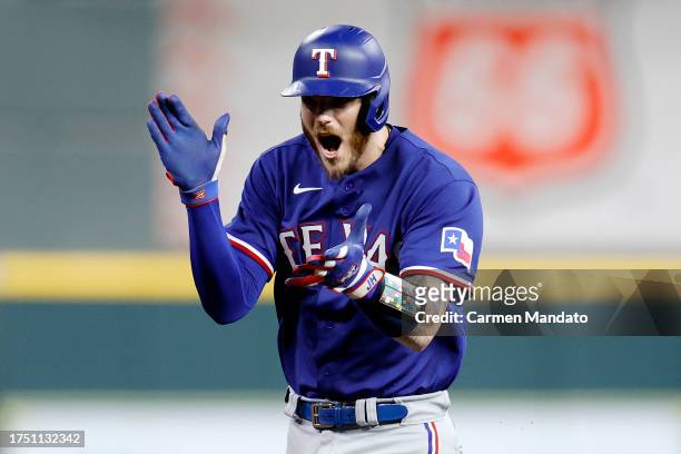 Jonah Heim of the Texas Rangers celebrates after hitting a two run home run against Framber Valdez of the Houston Astros during the fourth inning in...