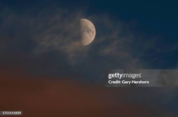 Percent illuminated waxing gibbous moon rises over New York City as the sun sets on October 22 as seen from Bayonne, New Jersey.