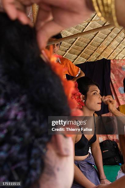 Zaw Moe, a medium, is getting dressed before dancing at the Taungbyon nat festival. Every year in August, hundreds of thousands of people from all...