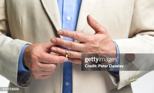 Divorced man taking off wedding ring Divorced man taking off wedding ring