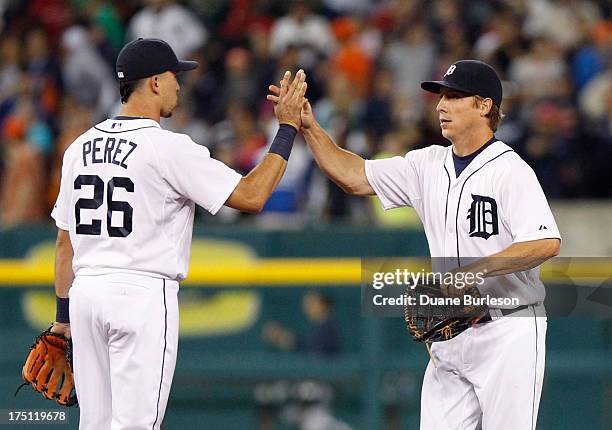Hernan Perez and Andy Dirks of the Detroit Tigers celebrate a 10-0 win over the Philadelphia Philles at Comerica Park on July 27, 2013 in Detroit,...