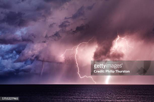 lightning storm with a tornado waterspout in the ocean - lightning purple stock pictures, royalty-free photos & images