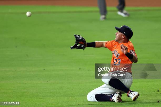 Michael Brantley of the Houston Astros catches a fly ball against the Texas Rangers during the eighth inning in Game Six of the American League...