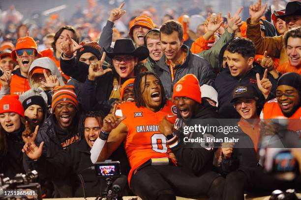 Running back Ollie Gordon II of the Oklahoma State Cowboys celebrates with fans after rushing for 271 yards with two touchdowns and 21 yards...