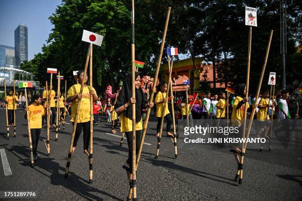 Students use traditional game equipment during the "Trophy Experience" event in Surabaya on October 29 ahead of the start of the FIFA U-17 World Cup...