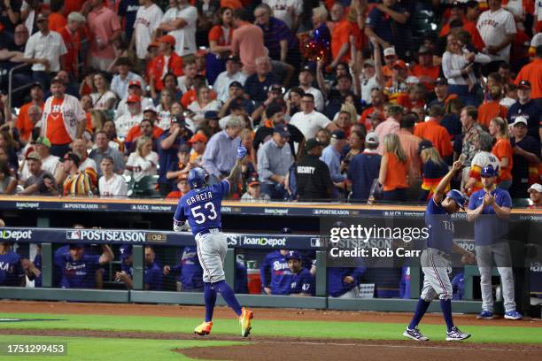 Adolis Garcia of the Texas Rangers celebrates after hitting a grand slam home run against Ryne Stanek of the Houston Astros during the ninth inning...