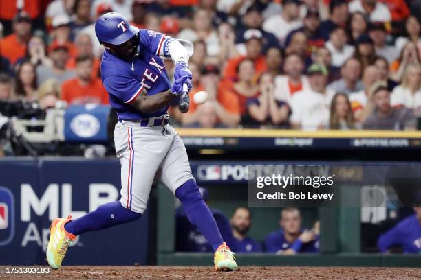 Adolis Garcia of the Texas Rangers hits a grand slam home run against Ryne Stanek of the Houston Astros during the ninth inning in Game Six of the...