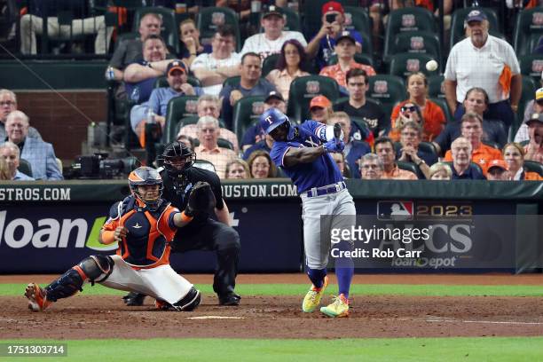 Adolis Garcia of the Texas Rangers hits a grand slam home run against Ryne Stanek of the Houston Astros during the ninth inning in Game Six of the...