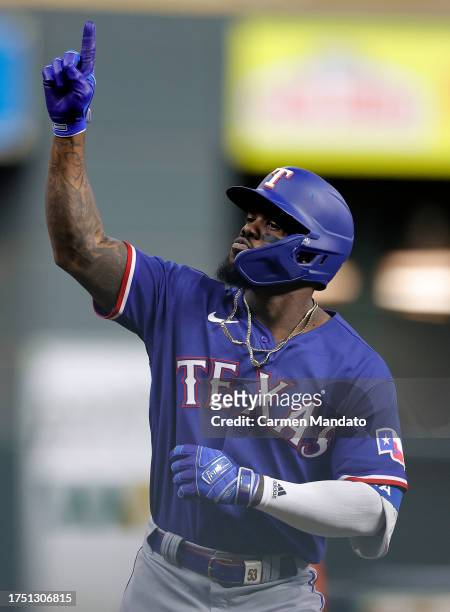 Adolis Garcia of the Texas Rangers celebrates as he rounds the bases after hitting a grand slam home run against Ryne Stanek of the Houston Astros...