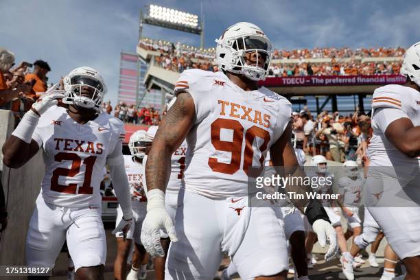 Byron Murphy II of the Texas Longhorns and Kitan Crawford take the field before the game against the Houston Cougars at TDECU Stadium on October 21,...