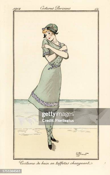 Woman on beach in swimming costume and bathing cap in two-tone taffeta. Costume de bain en taffetas changeant. Handcoloured pochoir etching after an...