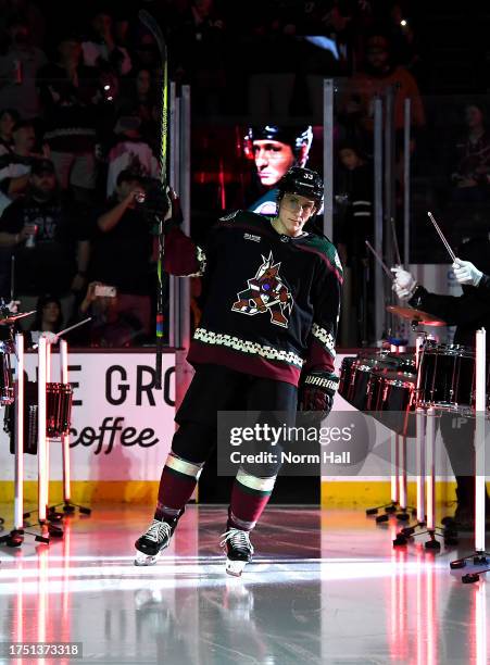 Travis Dermott of the Arizona Coyotes skates onto the ice during opening night player introductions against the Anaheim Ducks at Mullett Arena on...