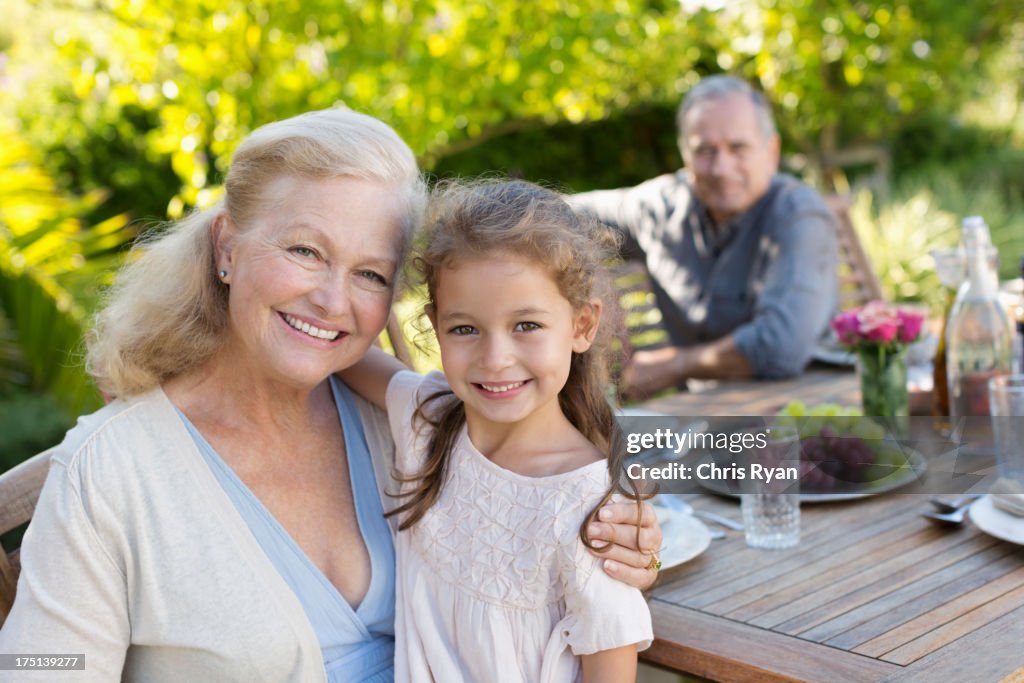 Older woman and granddaughter smiling outdoors