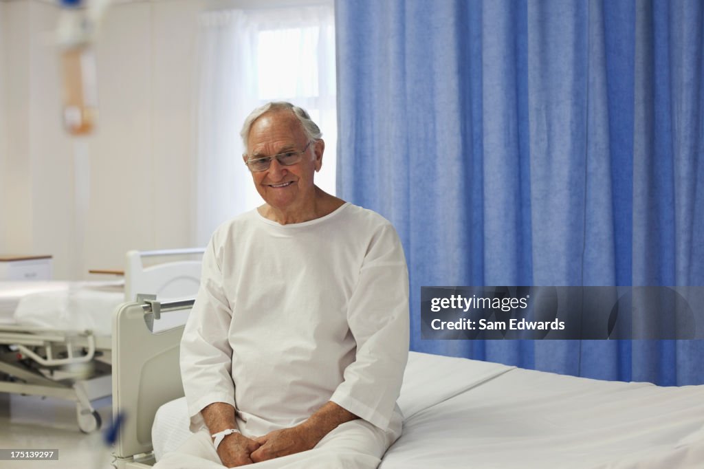 Older patient sitting on hospital bed