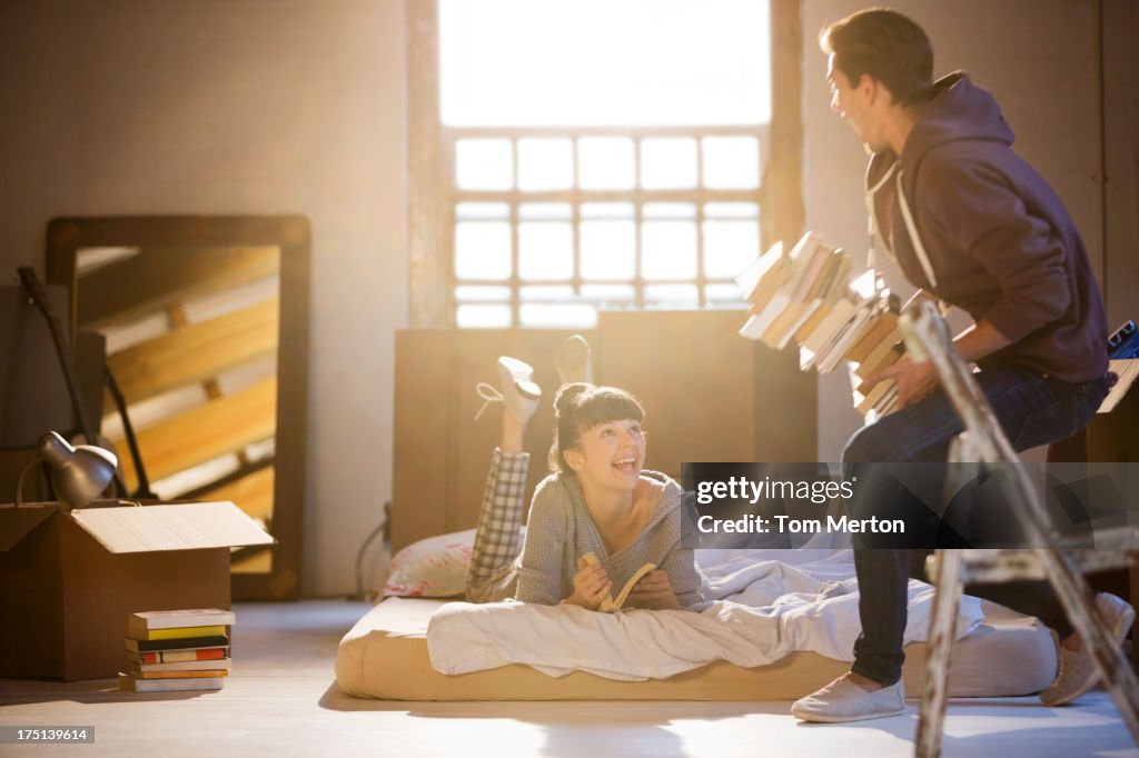 Couple relaxing in attic