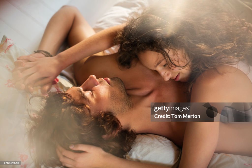 Couple relaxing together in bed