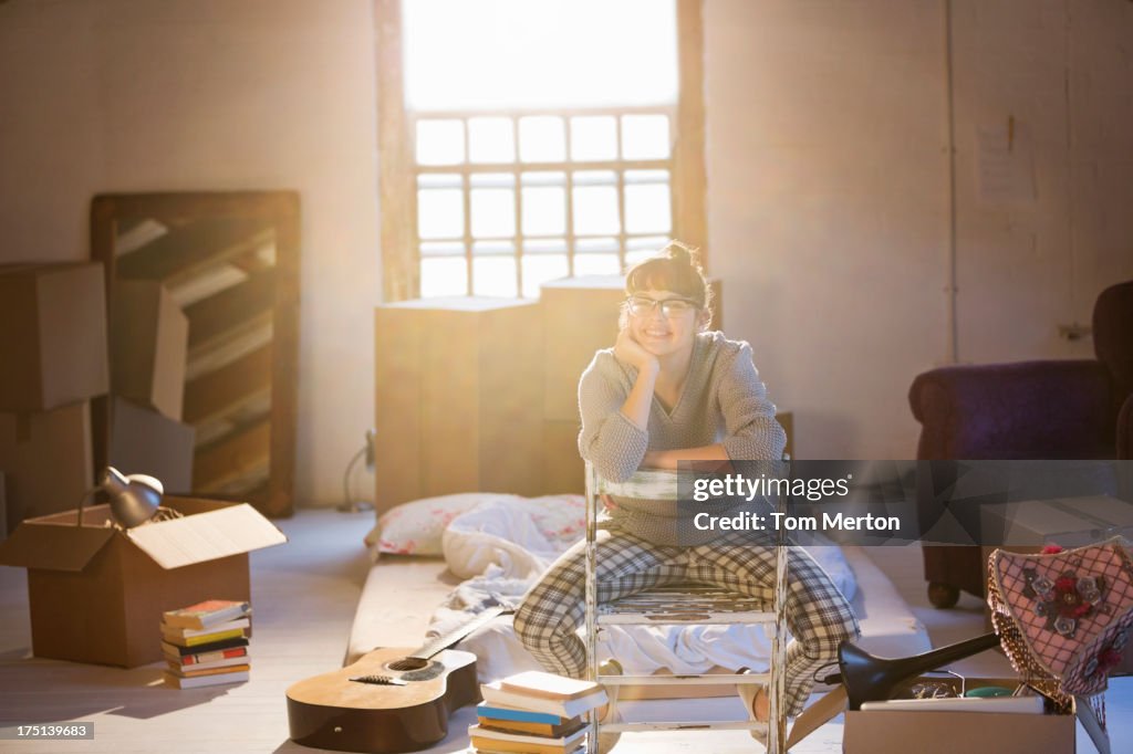 Woman unpacking boxes in attic