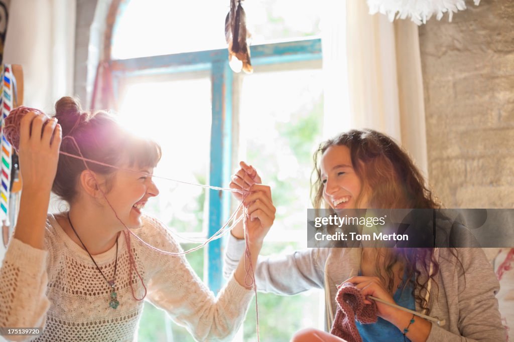 Women playing with yarn together