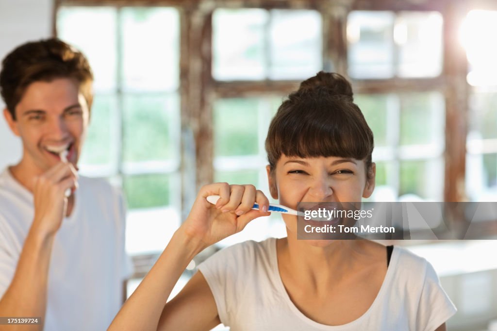 Couple brushing their teeth together