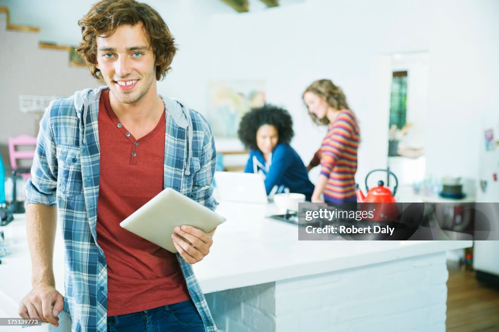 Man using tablet computer in kitchen