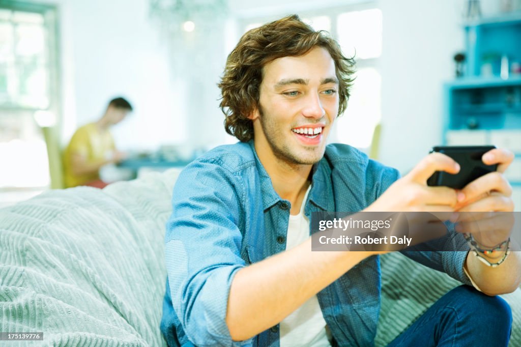 Man using cell phone in beanbag chair