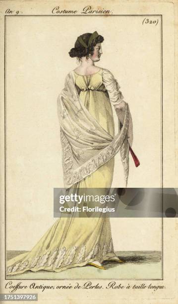 Rear view of fashionable woman in classical hairstyle ornamented with pearls, 1801. She wears a high-waisted long dress with lace veil. Coeffure...