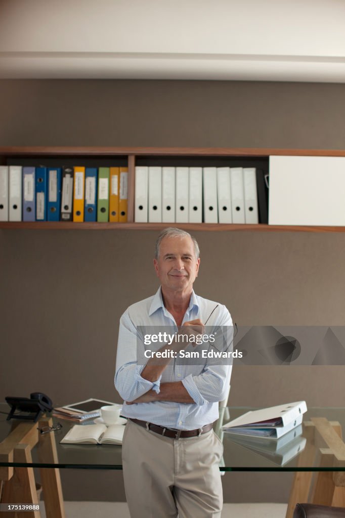 Older man standing in office