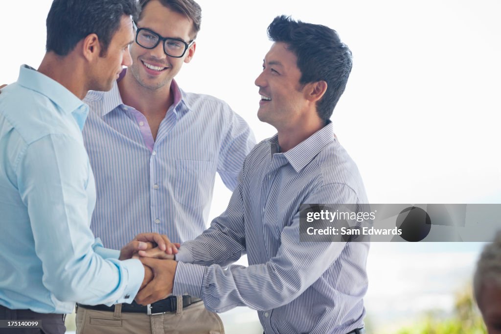 Businessmen shaking hands in office