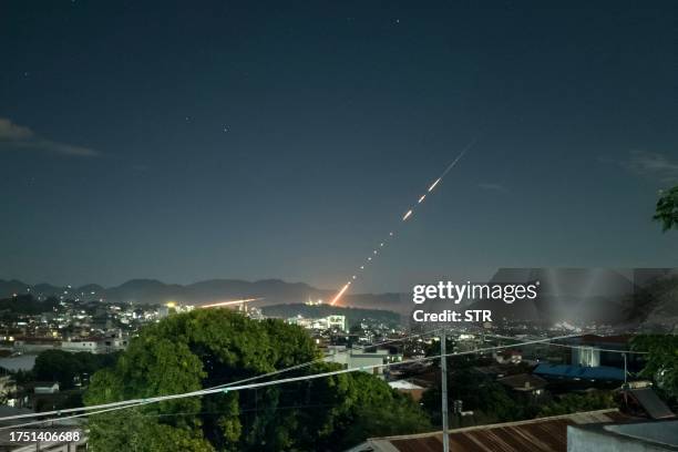 This long exposure picture taken late on October 28, 2023 shows a missile fired from a Myanmar military base in Lashio township, northern Shan State....