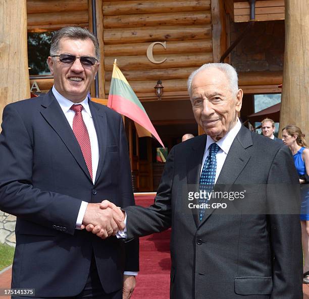 In this handout image provided by the Israeli Government Press Office , Israeli President Shimon Peres meets with Lithuanian Prime Minister Algirdas...