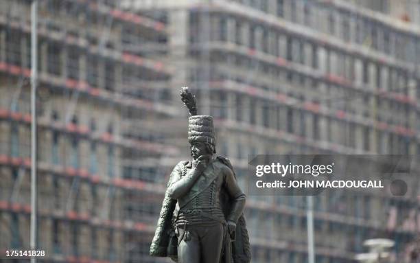 Statue of Prussian General Hans Joachim von Zieten stands in front of a construction site for a new shopping mall at Leipziger Platz in Berlin on...