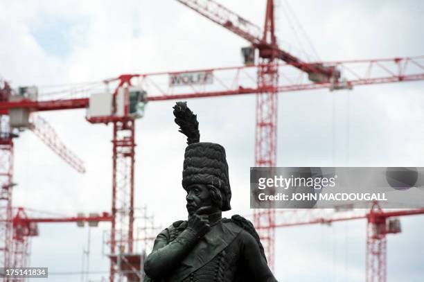 Statue of Prussian General Hans Joachim von Zieten stands in front of a construction site for a new shopping mall at Leipziger Platz in Berlin on...