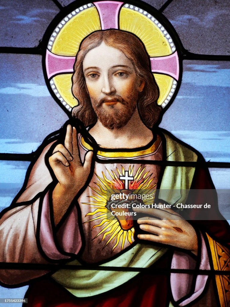 Close-up of a colorful stained glass window depicting Jesus Christ in Combloux, Haute-Savoie, France