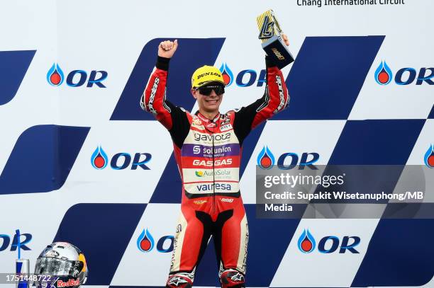 No.80 David Alonso of Colombia and GASGAS Aspar Team celebrates the victory on the podium during the Moto3 race during the MotoGP of Thailand at...