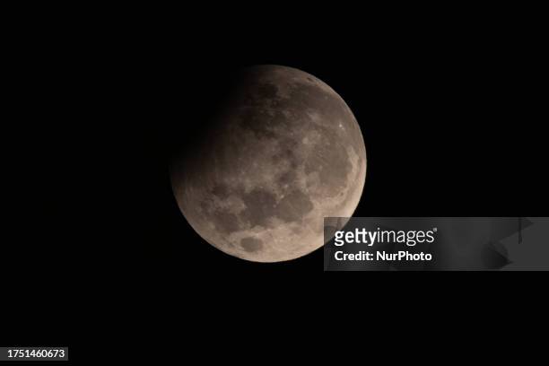 Partial moon eclipse is seen from Ungaran, Central Java Province, Indonesia on October 29, 2023. 6% of the lunar surface will be temporarily deprived...