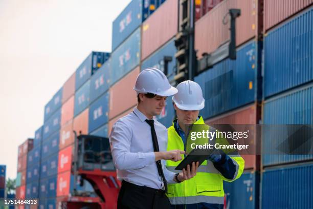 logistics engineer explaining to controlling daily shipment of container box to customer in time and right position in container ship yard. - complex problem solving stock pictures, royalty-free photos & images