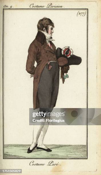 Directoire gentleman in gala fashion with high-collared riding coat, waistcoat, cravatte, hat with cockade, 1801. Costume pare. Handcoloured...