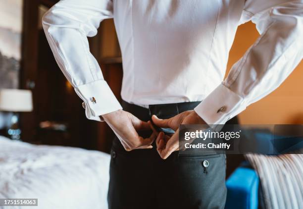 asian man putting on tuxedo for events - cuff sleeve stock pictures, royalty-free photos & images