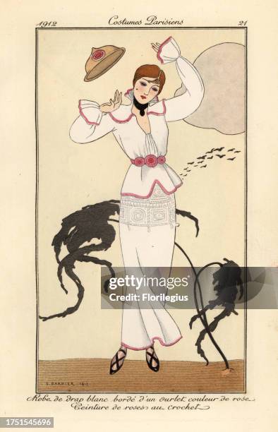 Woman in white wool dress with pink trim, belt of crocheted roses, losing her hat in the wind. Robe de drap blanc borde d’un ourlet couleur de rose,...