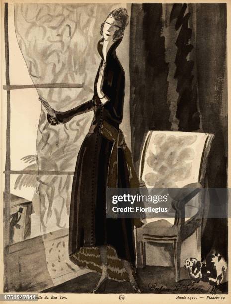 Woman in asymetrical dress waiting at a window with dog. Finally! He’s arrived. The dress is of black crepe de chine with gold accents. Enfin! Le...