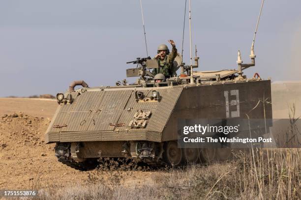 Female Israel soldiers are seen driving an armoured personnel carrier in southern Israeli near the border with Gaza on October 28,2023. .