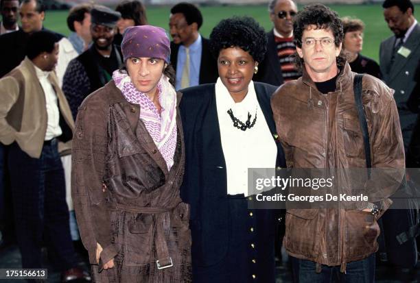 American musician Little Steven, Winnie Madikizela-Mandela and American musician Lou Reed attend backstage a concert held at Wembley Stadium to...