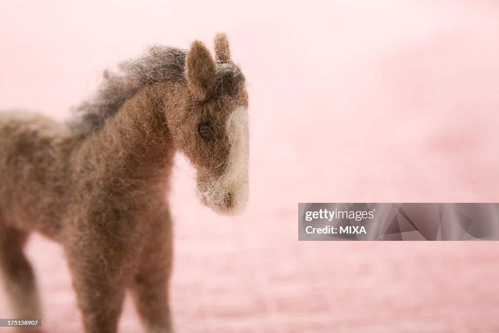 Felt Toy Horse on Pink Paper
