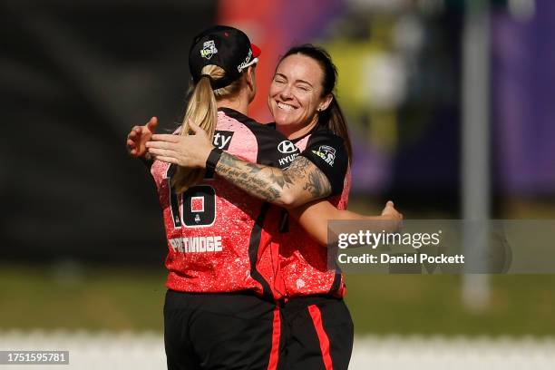 Sarah Coyte of the Renegades celebrates with Georgia Prestwidge of the Renegades after combining to dismmiss Maddie Penna of the Strikers during the...