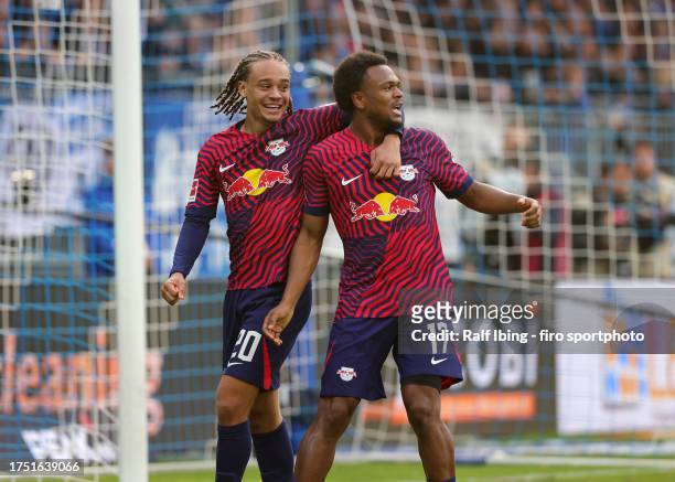 Lois Openda of RB Leipzig celebrates with teammate Xavi Simons after scoring his teams third goal during the Bundesliga match between SV Darmstadt 98...