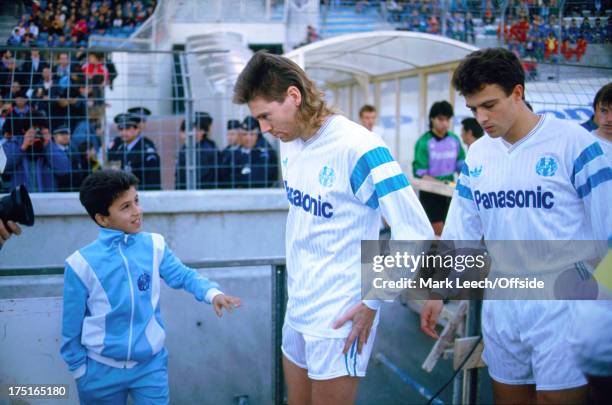 December 1989 - French Football - Marseille v Nice - a young Marseille ball boy looks up at Chris Waddle as he appears from the players tunnel.